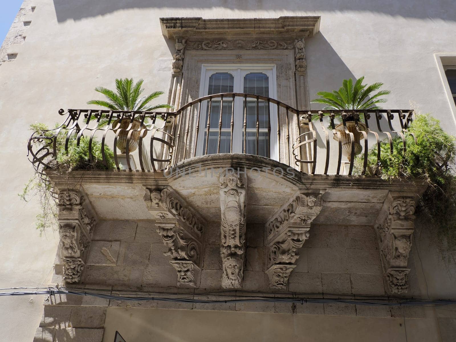 balcony sculpture ortigia syracuse old buildings street view on sunny day Sicily, Italy