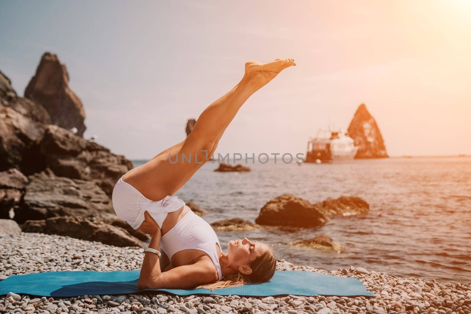 Woman sea yoga. Back view of free calm happy satisfied woman with long hair standing on top rock with yoga position against of sky by the sea. Healthy lifestyle outdoors in nature, fitness concept.