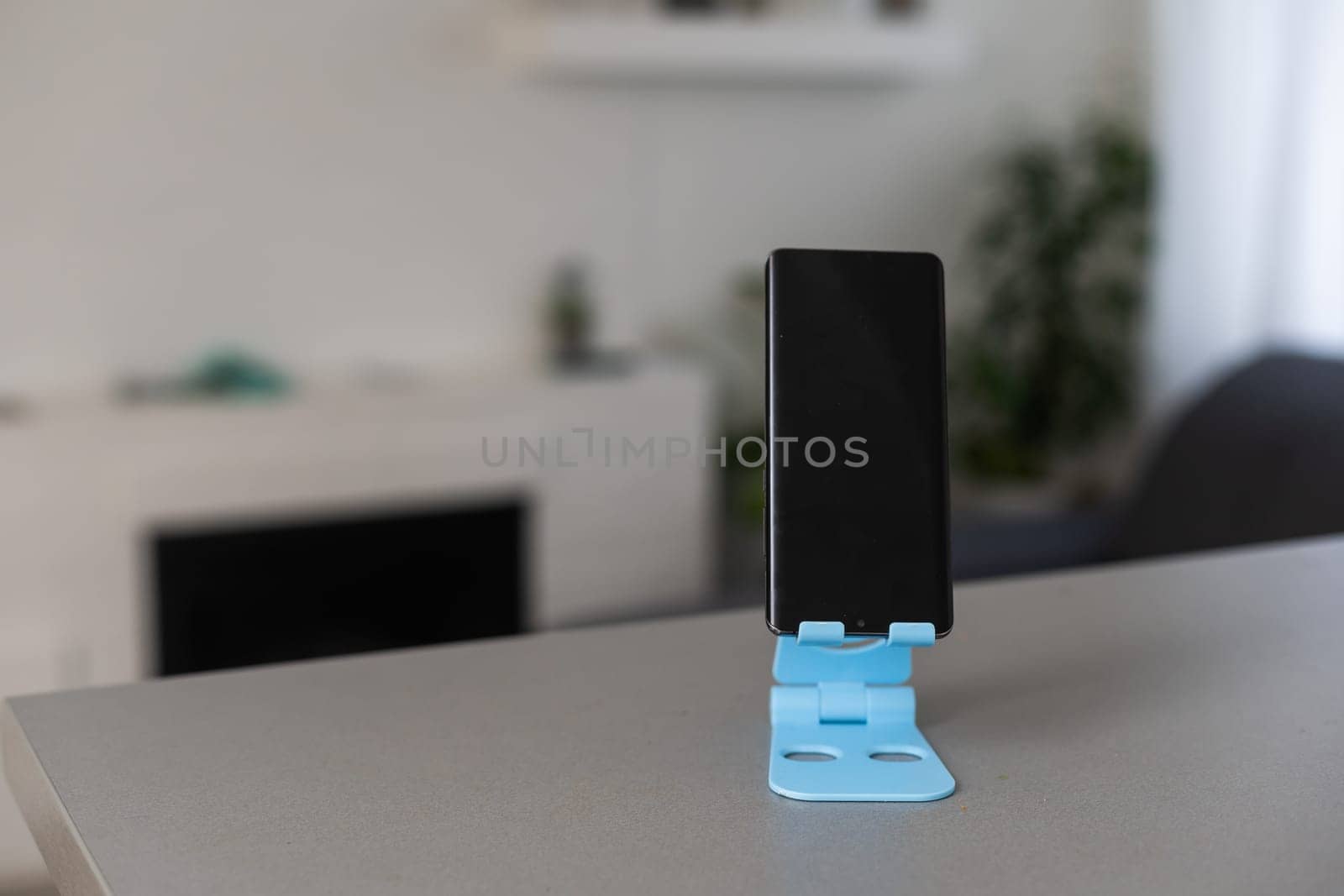 Smartphone stand on mobile holder.
