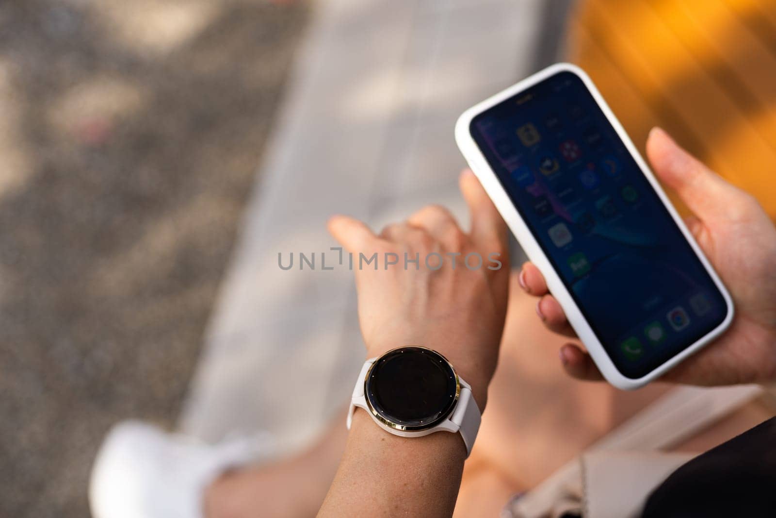 phone in the hands of a girl and a smart watch on her hand mockup by Andelov13