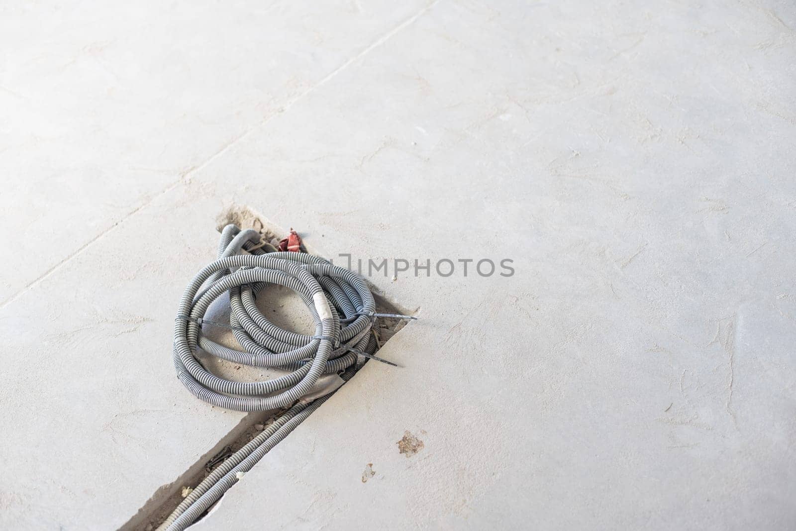 Rope hoist lifting steel frame with cement wall in the room. High quality photo