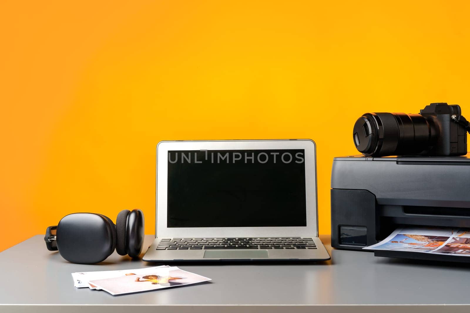 Printer, laptop and camera on the table close up. Printing photos