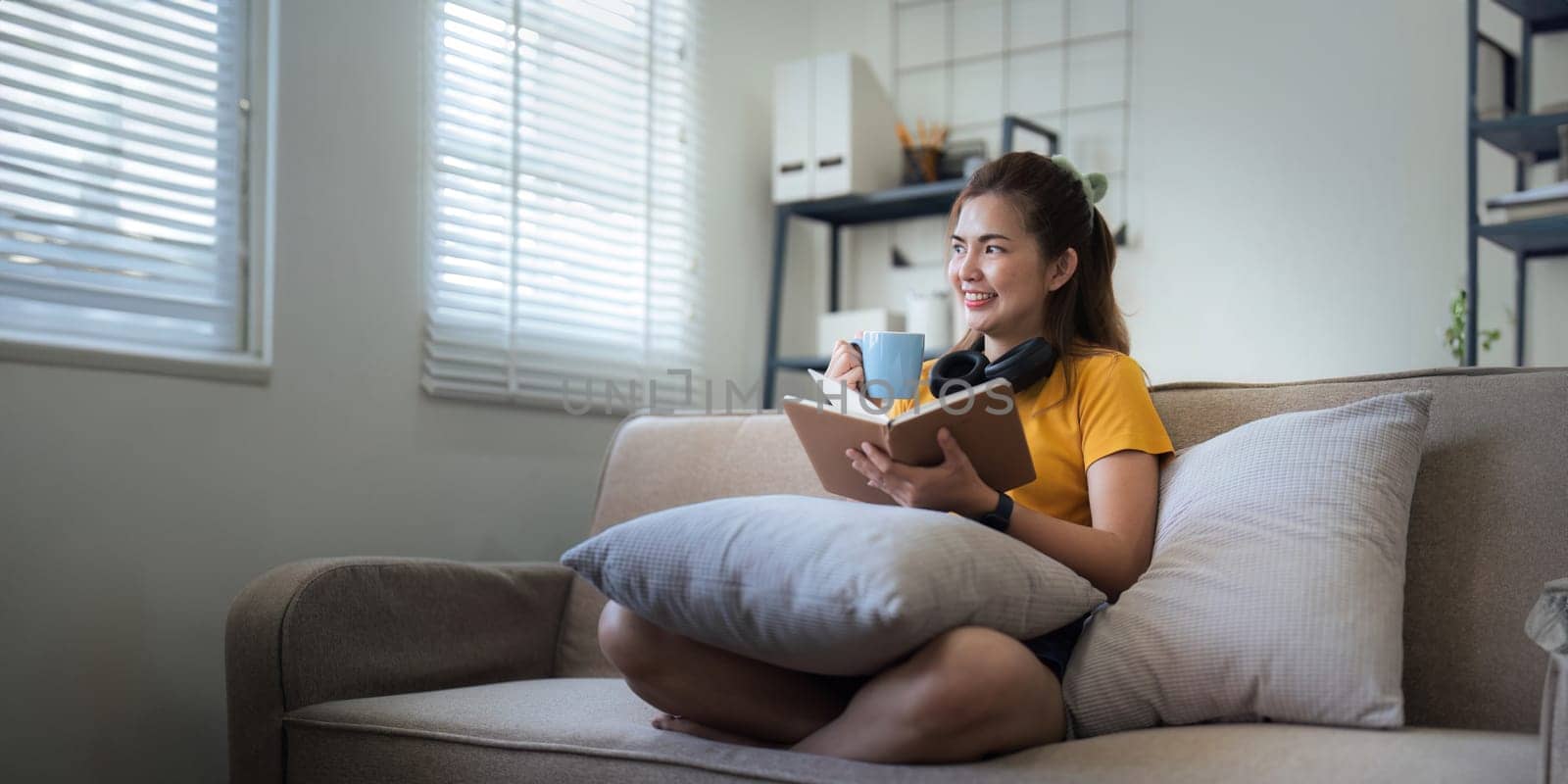 Happy young woman read book on sofa at home. Lifestyle freelance relax in living room. lifestyle relaxation concept.