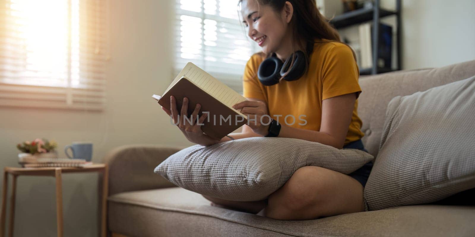 Happy young woman read book on sofa at home. Lifestyle freelance relax in living room. lifestyle relaxation concept.