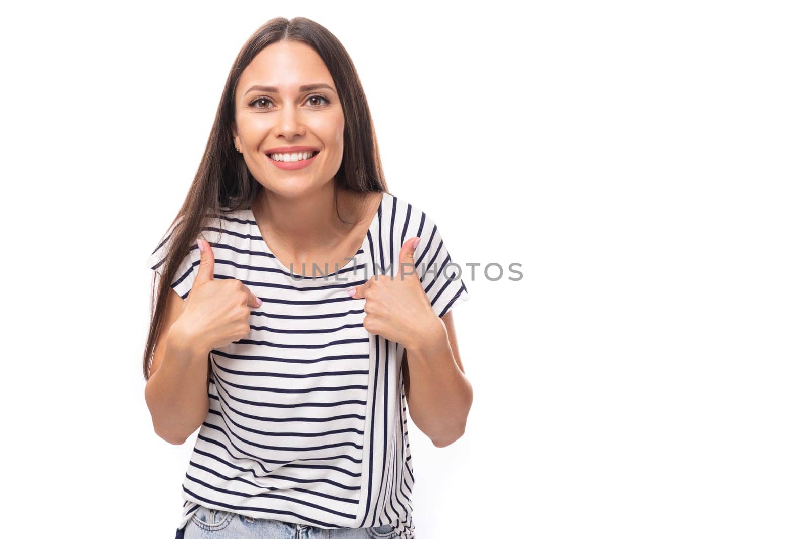 young cheerful energetic caucasian brunette woman in a striped t-shirt smiling on a white background with copy space by TRMK