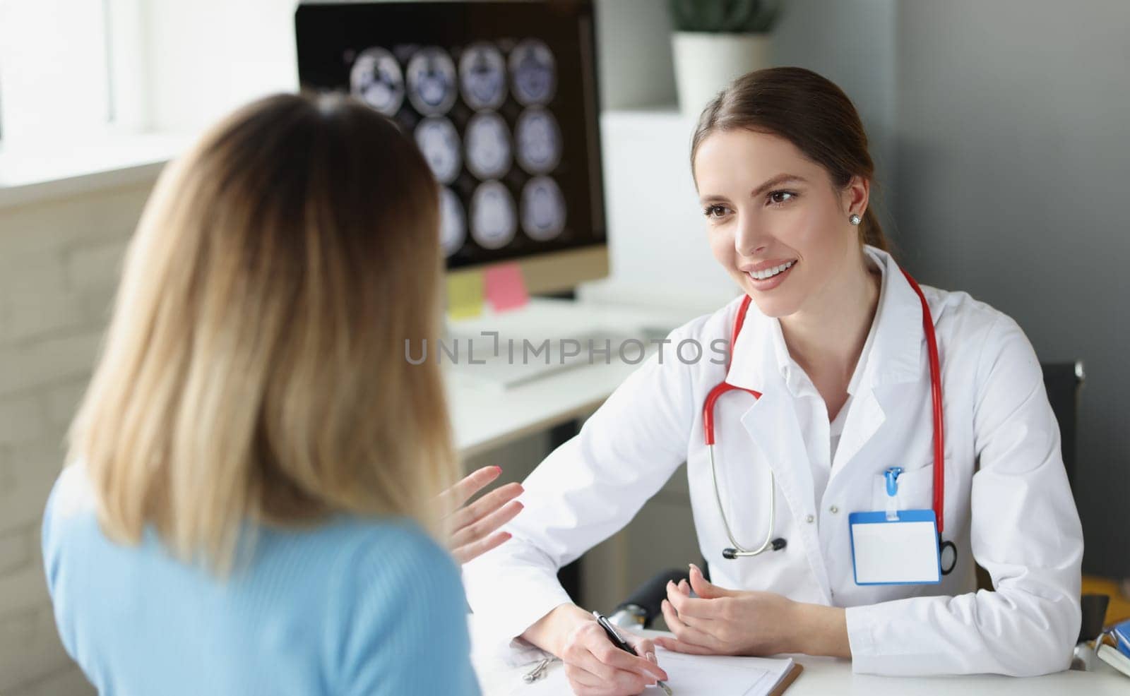 Woman sitting at appointment of gynecologist in clinic. Outpatient medical care concept