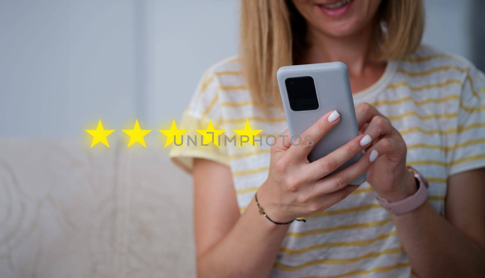 Woman holding mobile phone in her hands and giving five star rating for quality of services closeup. Online review concept