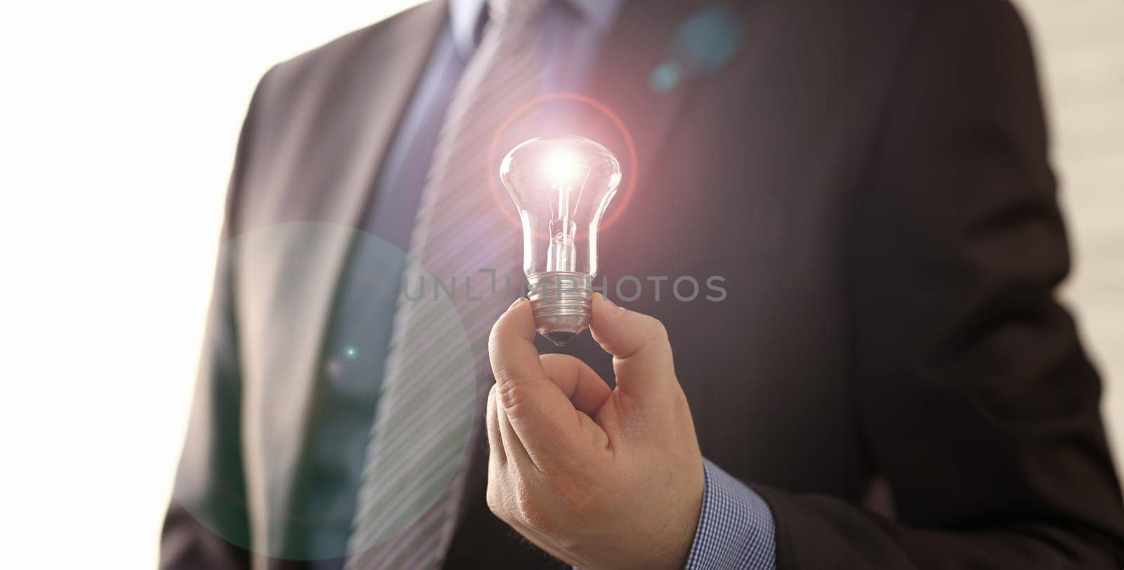 Innovation Technology New Creative Business Vision. Office Man in Suit Holding Traditional Light Bulb. Executive Manager with Lamp in Hand. Inspiration Symbol. Saving Electric Energy Solution