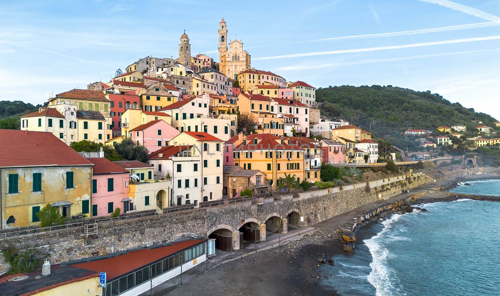 drone aerial photograph shows the church and historic structures in the Italian village of Cervo on the Ligurian coast
