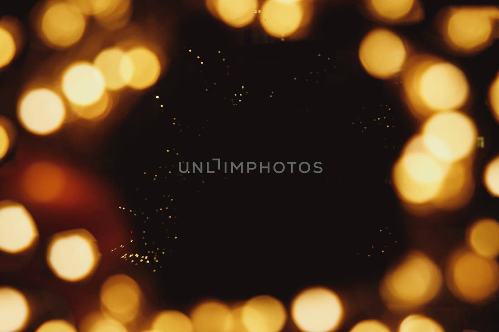 Frame with golden light bokeh on black background. Festive mock up. Defocused, blurred lights, yellow spots. Christmas, birthday party, holiday, romantic card concept. Copy space.glitter texture by YuliaYaspe1979