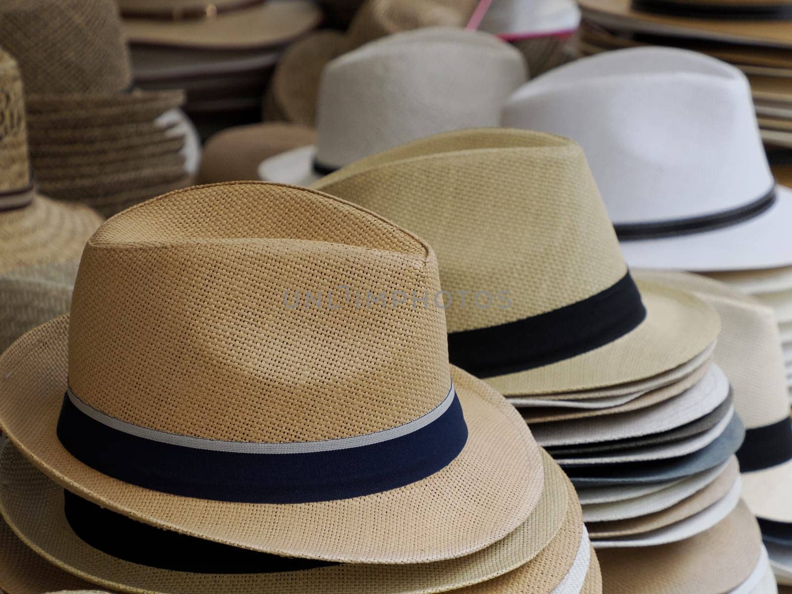 Many Panama hats in a store market by AndreaIzzotti