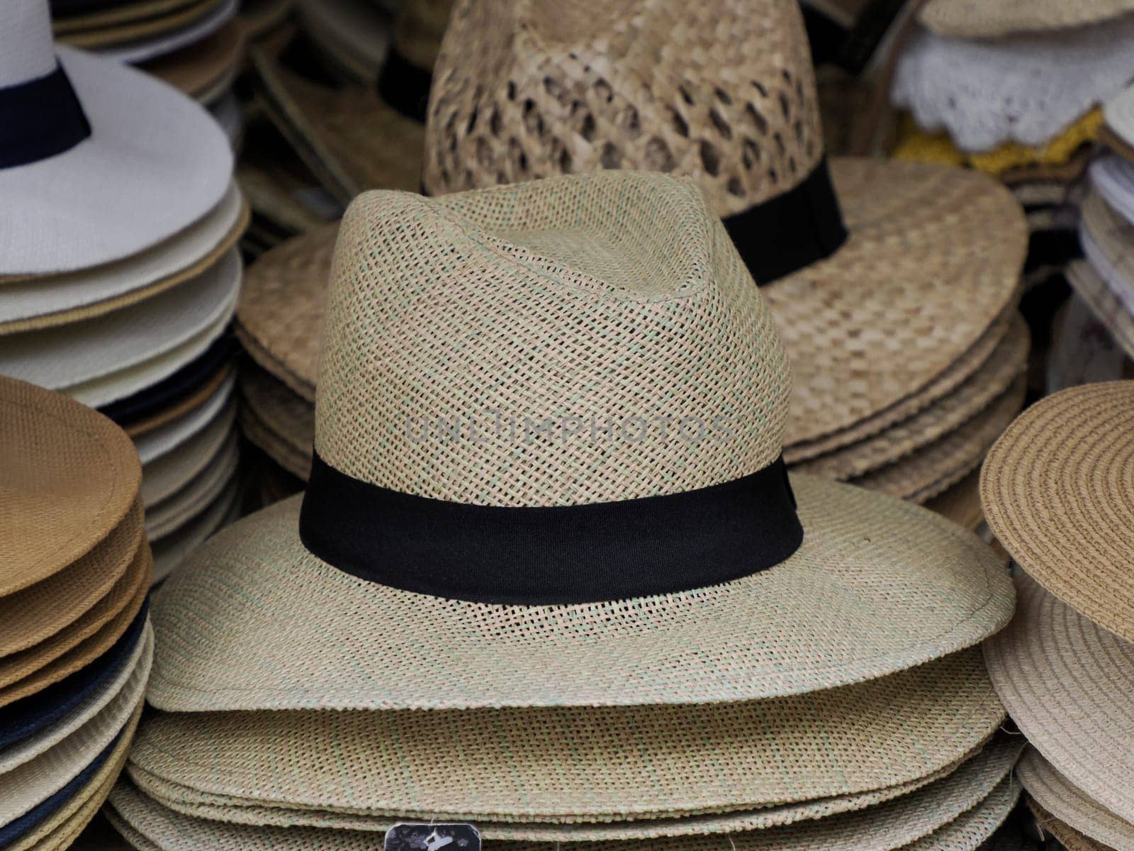 Many Panama hats in a store market by AndreaIzzotti