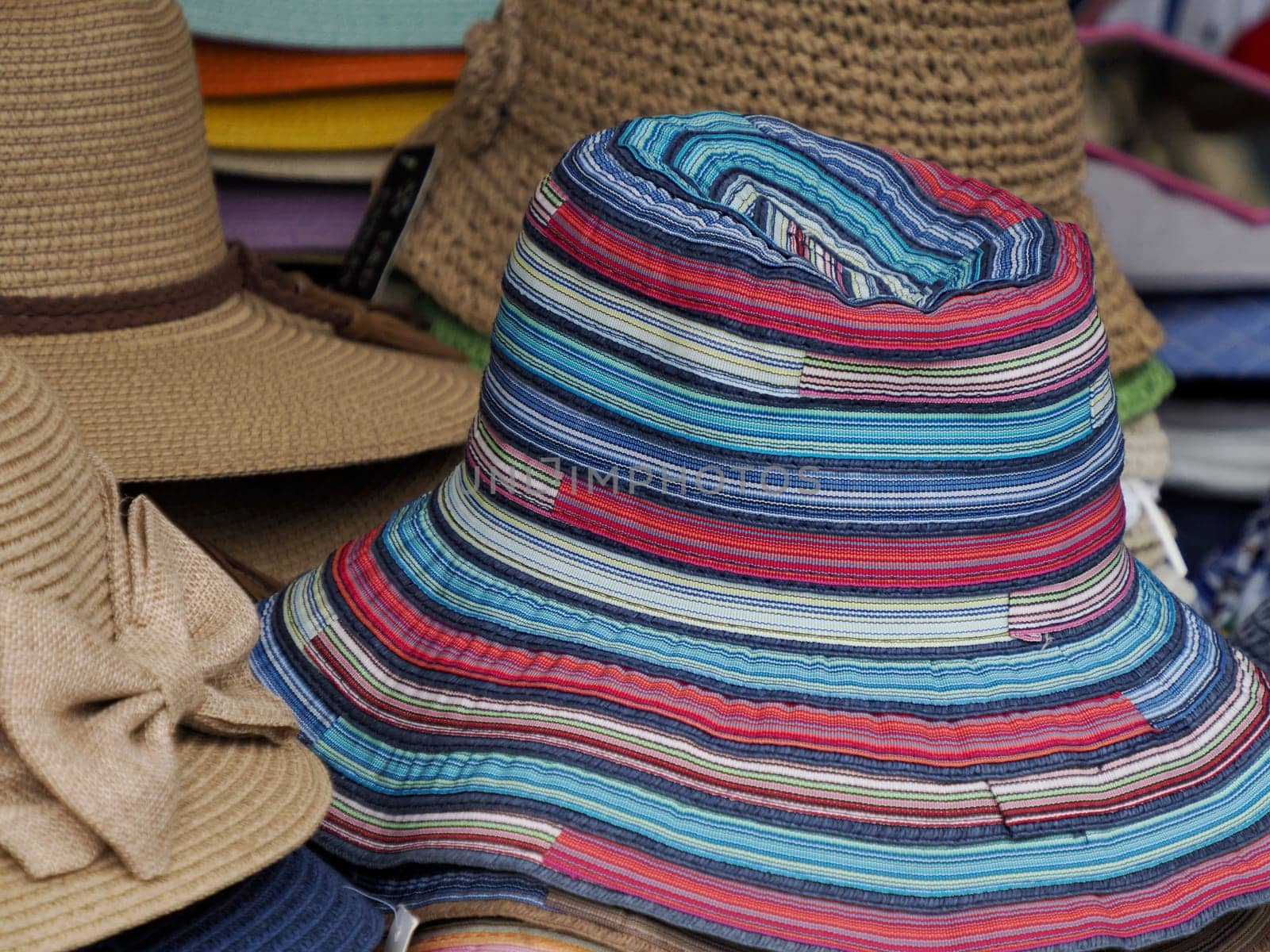 Many Panama hats in a store market by AndreaIzzotti