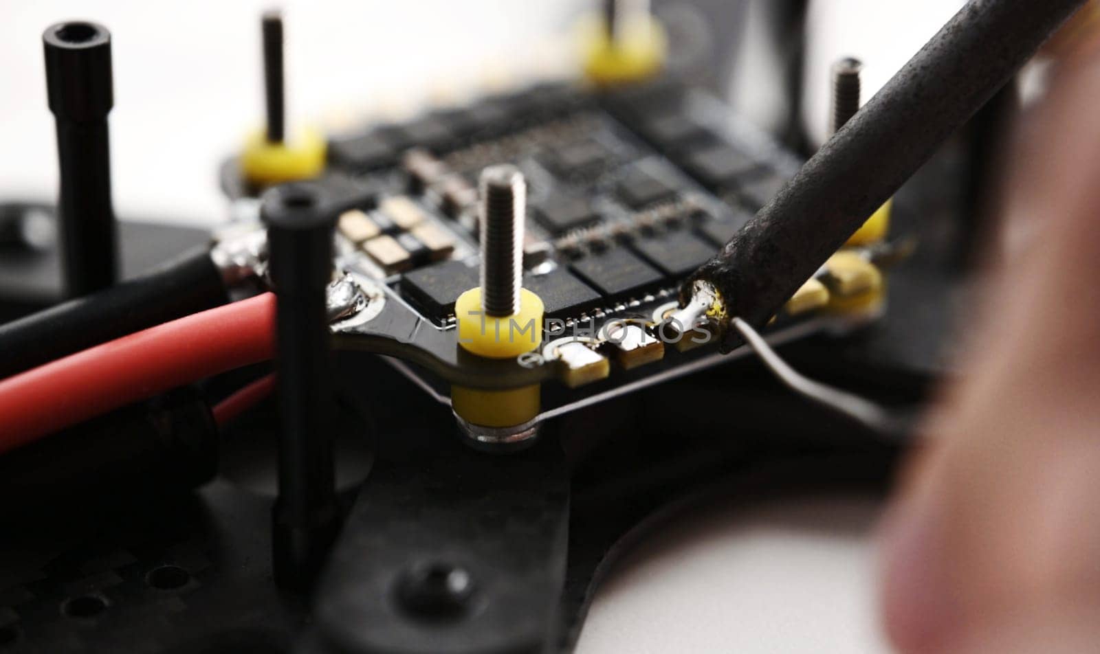 Process of soldering connections on microchip of fpv drone
