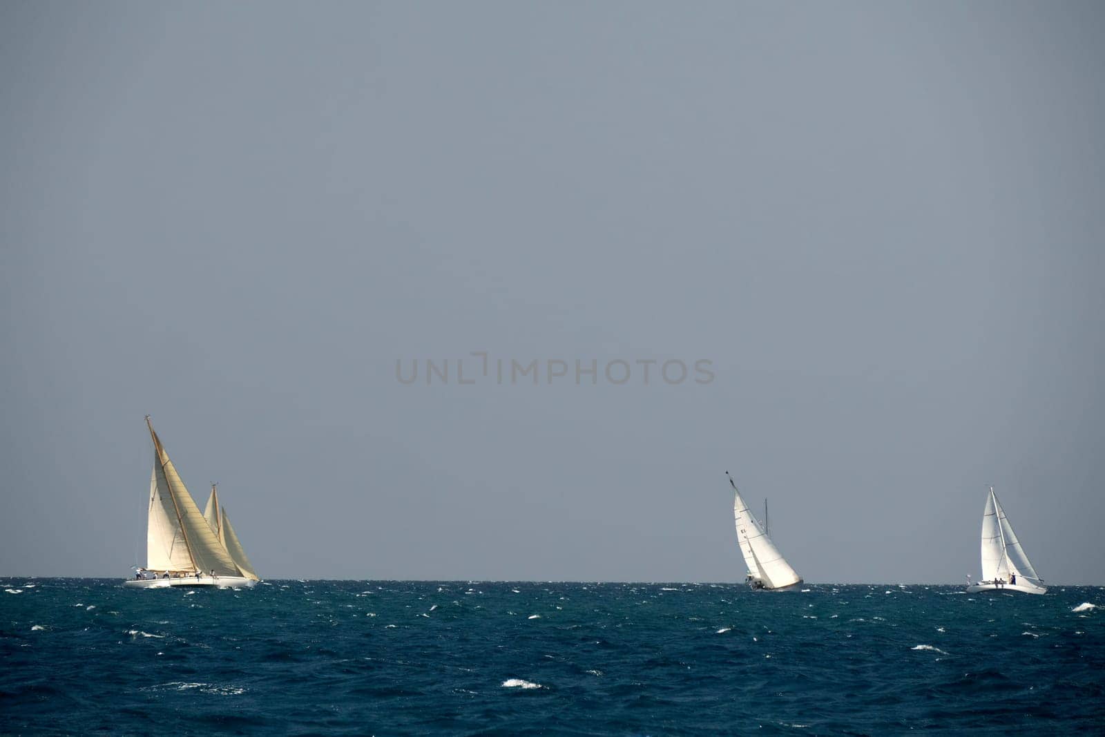 strong wind regatta in barcelona Sailing ship in a strong wind. Yachting by AndreaIzzotti
