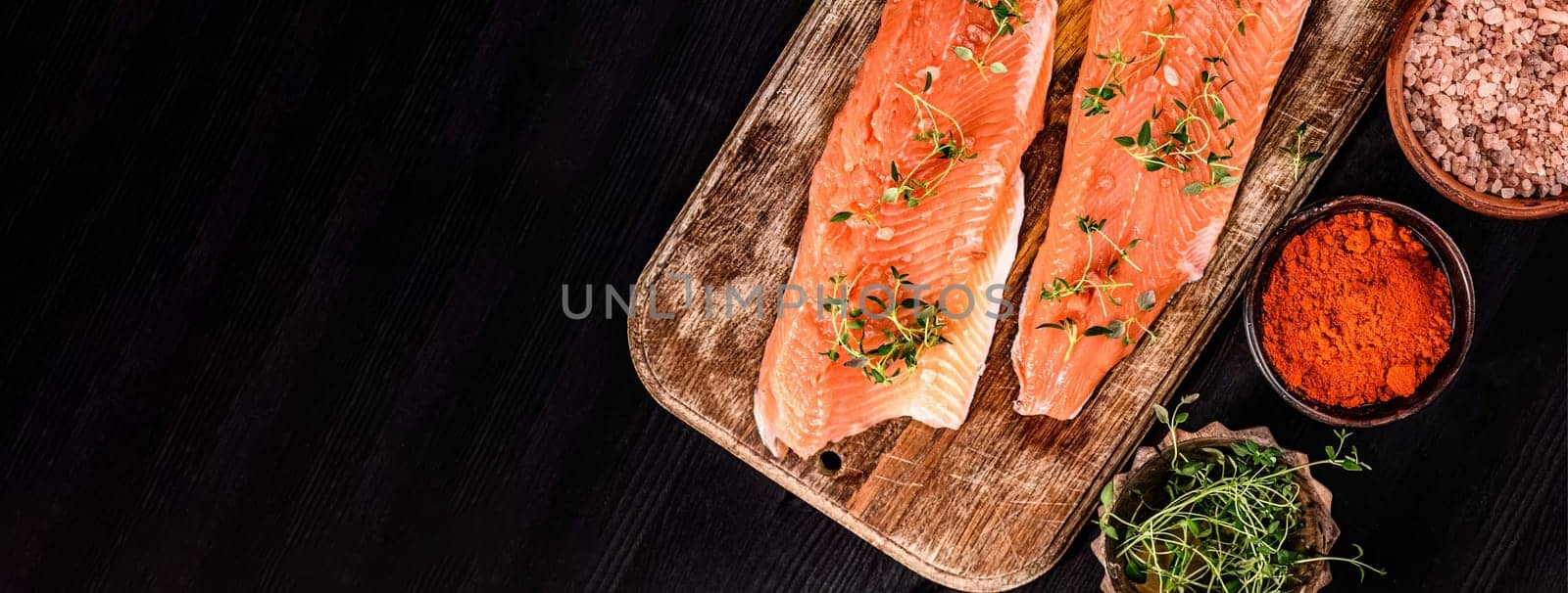 fillet of trout red fish with herbs and salt on a cutting board by GekaSkr