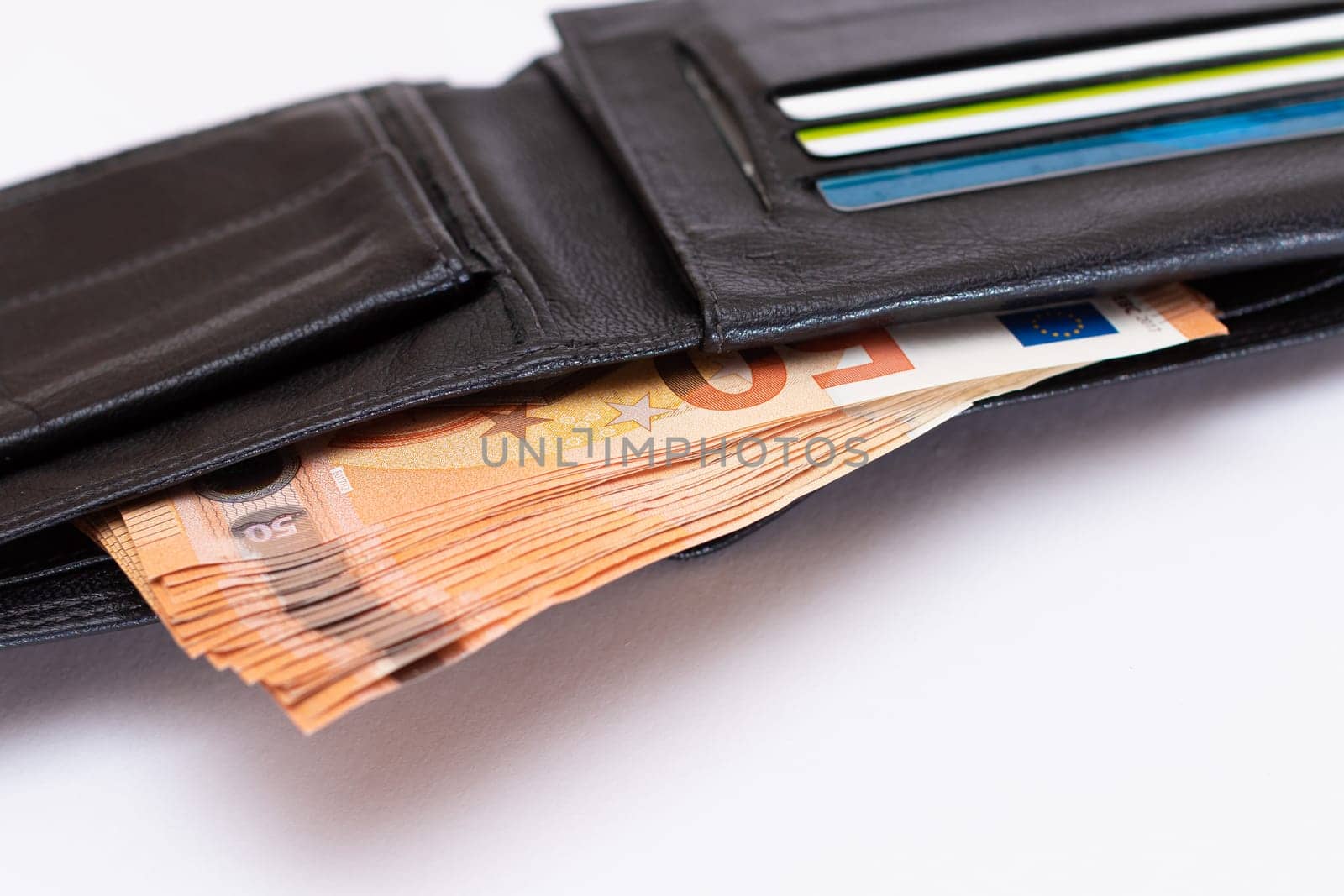 Opened Black Leather Men Wallet with Fifty Euro Banknotes and Bank Cards Inside on White Background. A Purse Full of Money and Credit Cards Symbolizing Wealth, Success and Social Status