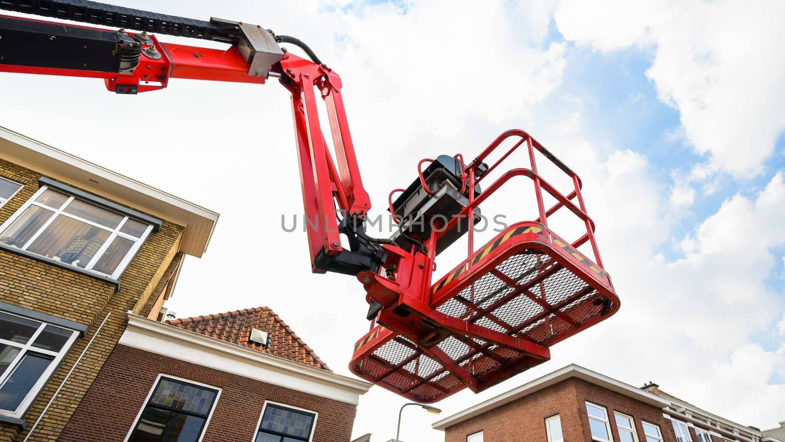 Aerial work platform for city communication repair services. Elevating cherry picker at europaen city street