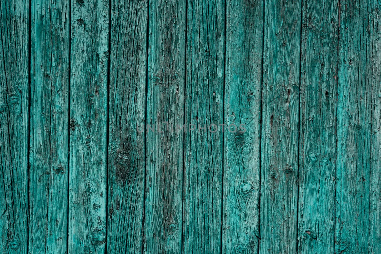 Old wooden blue planks fence textured Background with aged surface details. Weathered vintage rustic timber closeup