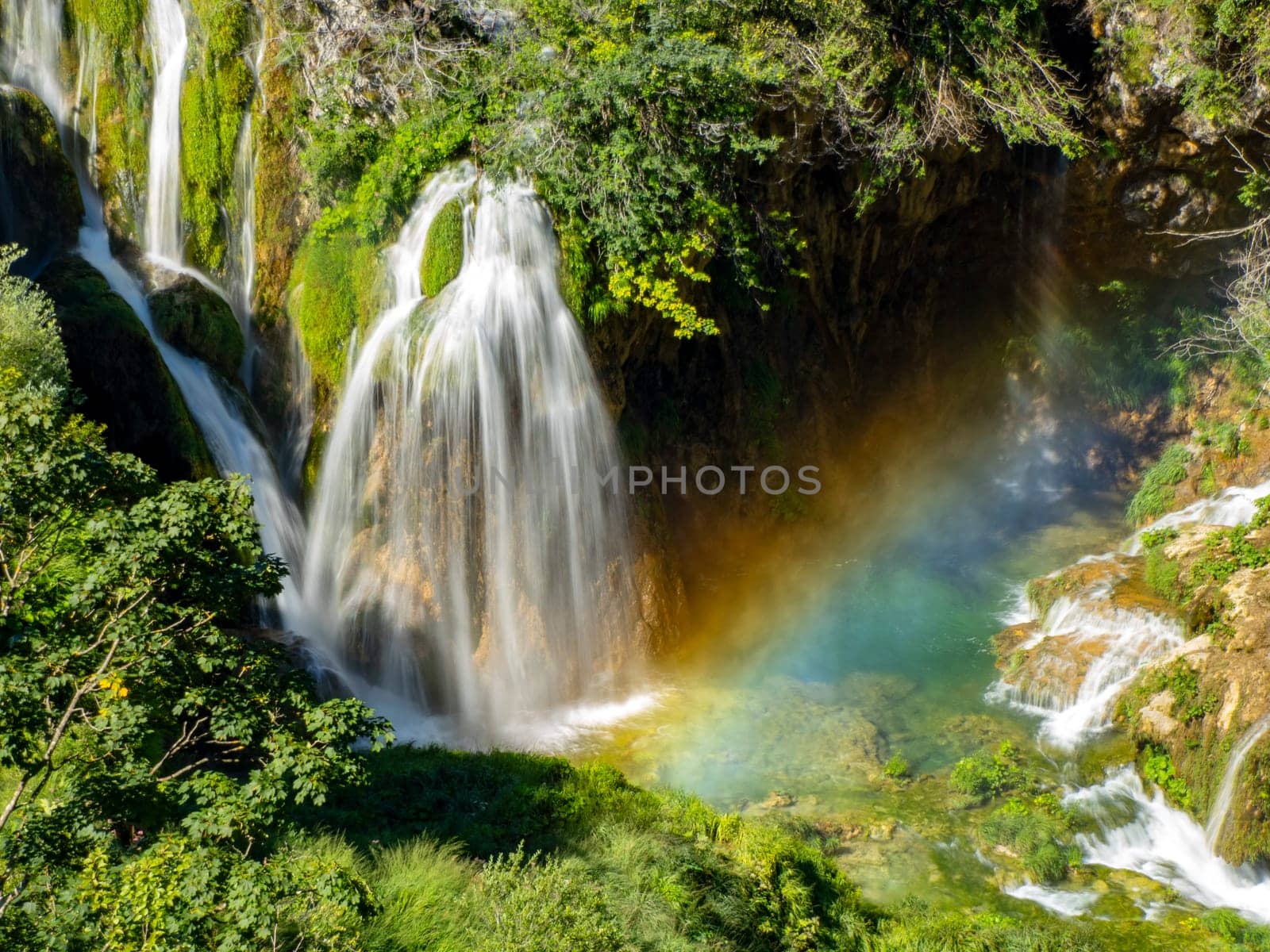 A Summer view of water lakes and beautiful waterfalls in Plitvice Lakes National Park, Croatia rainbow coming from splashes and drops.