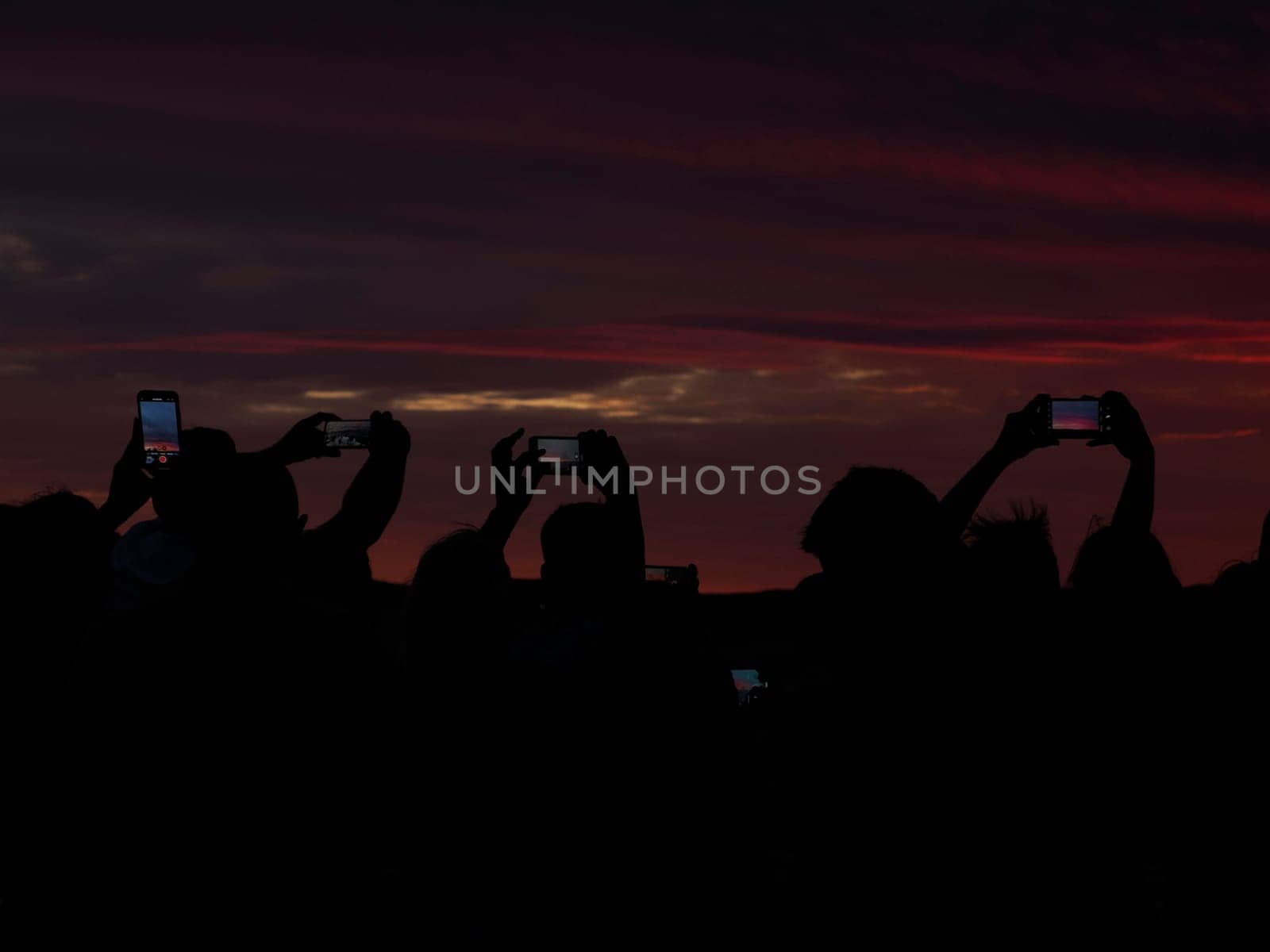 many people photographing red sunset