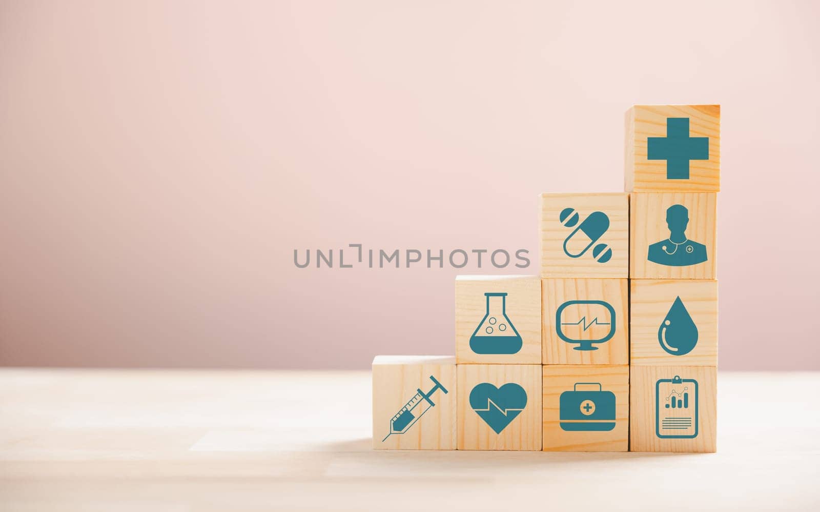 Pyramid crafted from wooden cubes symbolizes healthcare and insurance principles. Medical insurance icon atop indicates security. Blue background provides copyspace for Health Insurance concept.