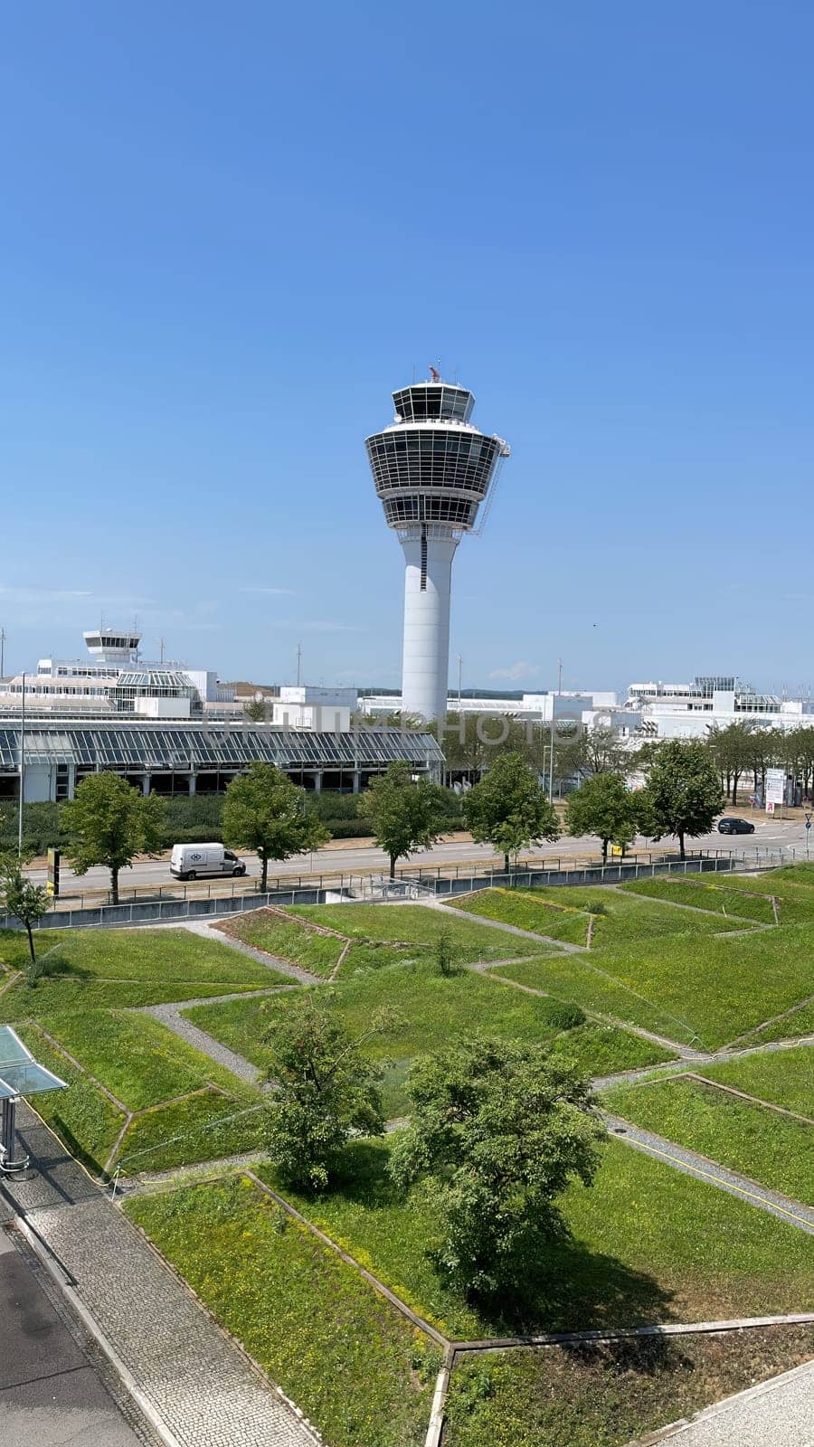 Airport control tower overseeing operations on a clear day. by AllesSuper