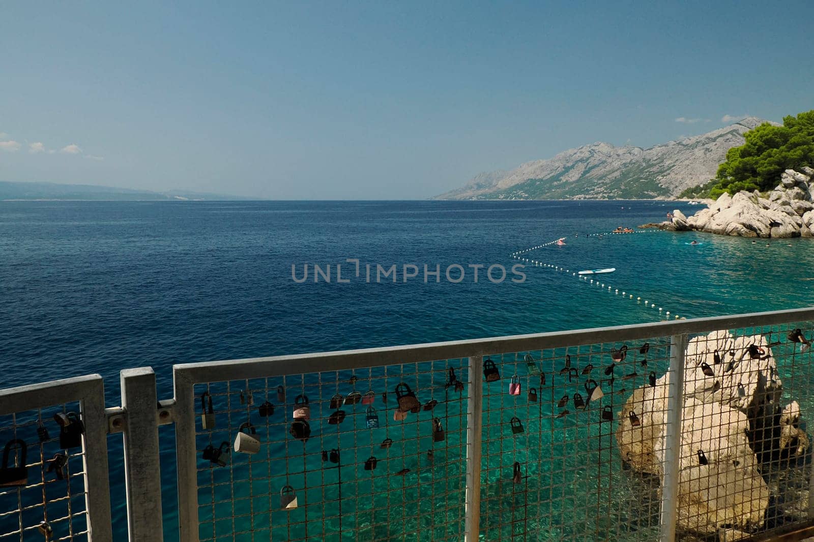 boardwalk over crystal clear water of Adriatic sea in Brela on Makarska Riviera, Dalmatia, Croatia by AndreaIzzotti