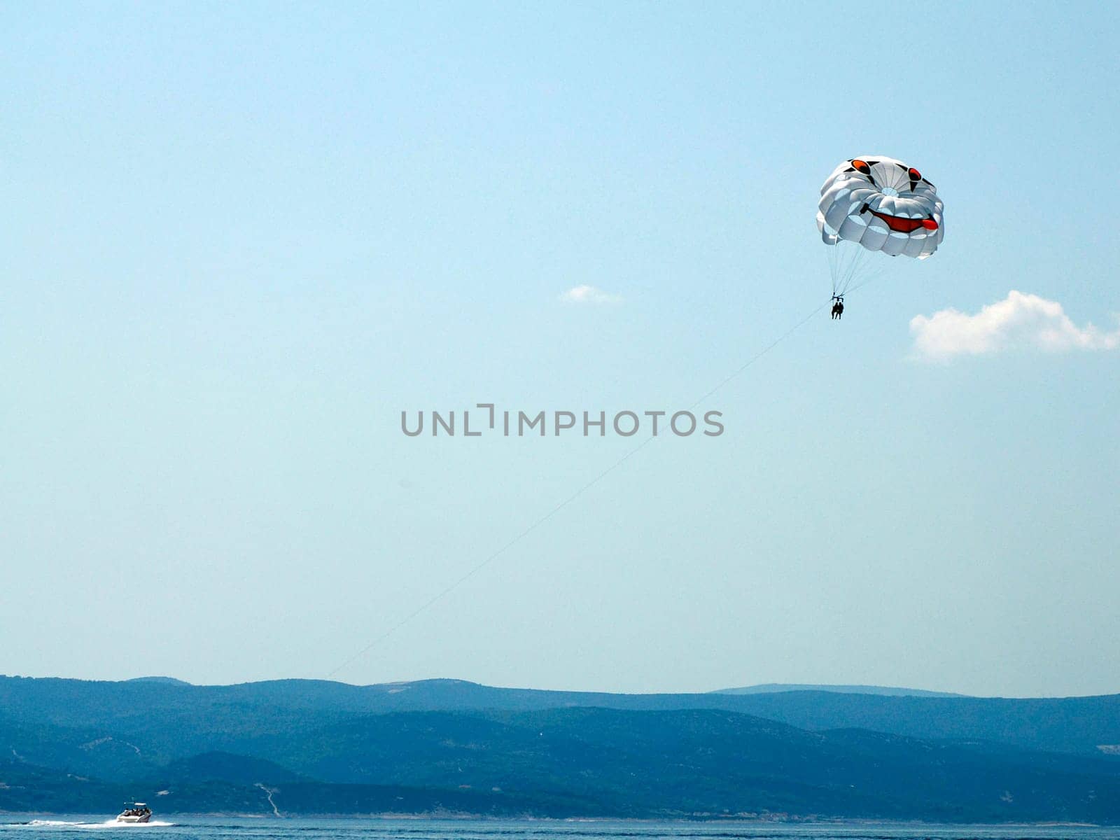 parachuting with speedboat over the crystal clear water of Adriatic sea in Brela on Makarska Riviera, Dalmatia Croatia