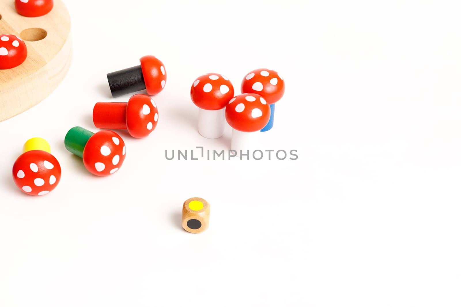 Children's educational board game with a wooden board and colorful mushrooms, isolated on white background, copy space by Rom4ek