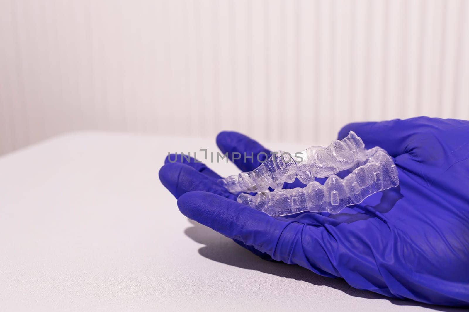 Closeup Invisible Orthodontics Cosmetic Aligners In Doctor's Hand. Adjusting Transparent, Invisalign Braces. Dental Care, Orthodontic. Copy Space For Text, Horizontal Plane. Mockup by netatsi