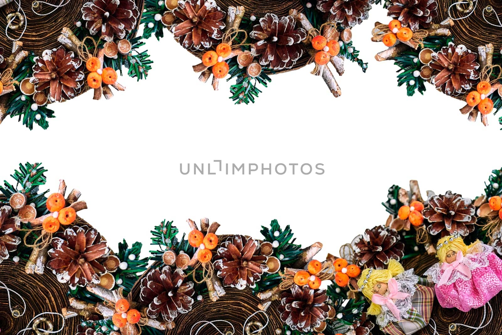 Christmas wreath with pine cones, toys on a white background. With angels in the middle.