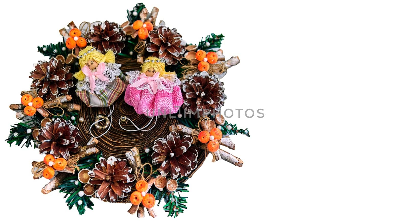 Christmas wreath with pine cones, toys on a white background. With angels in the middle.