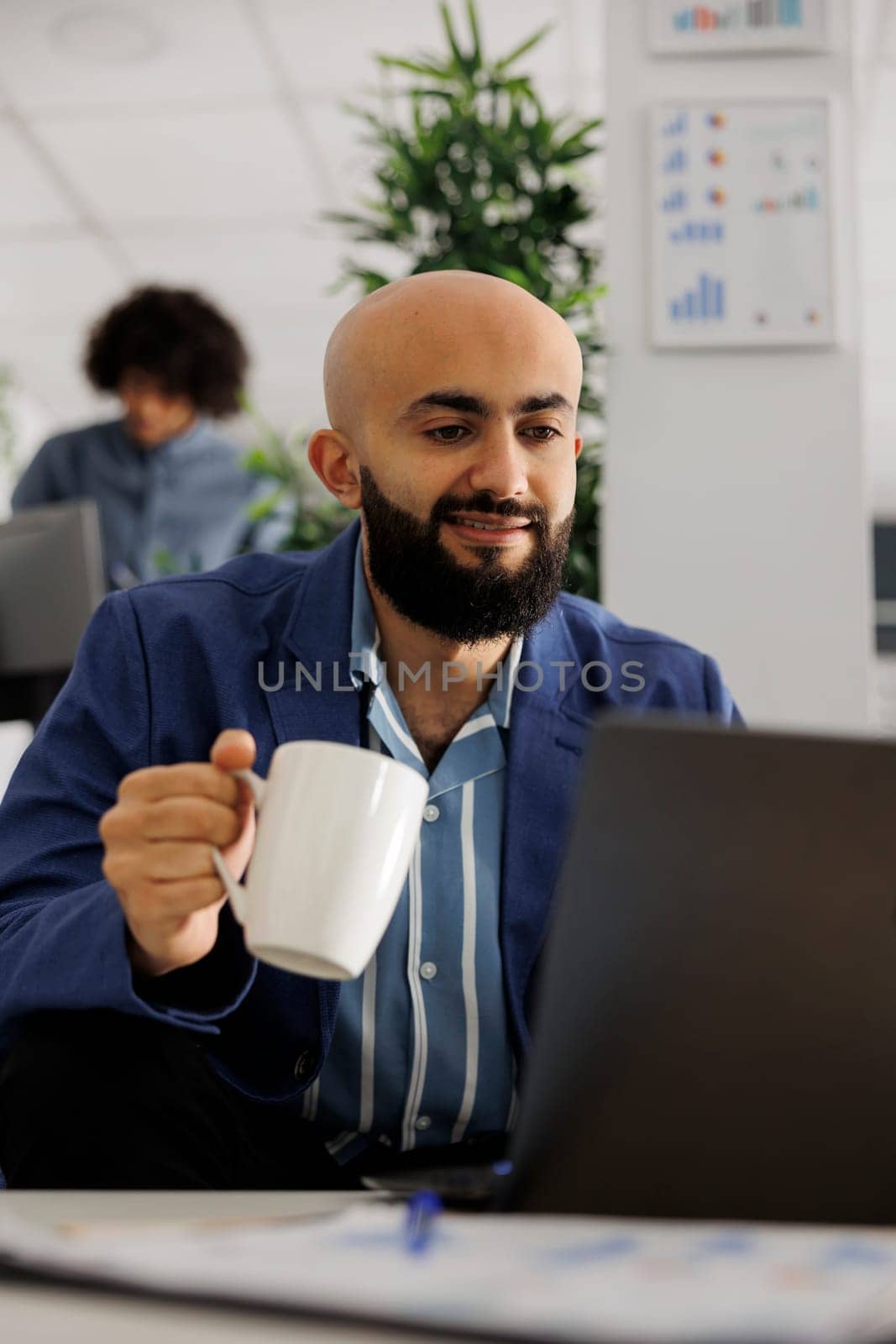 Smiling business company employee checking project financial report by DCStudio