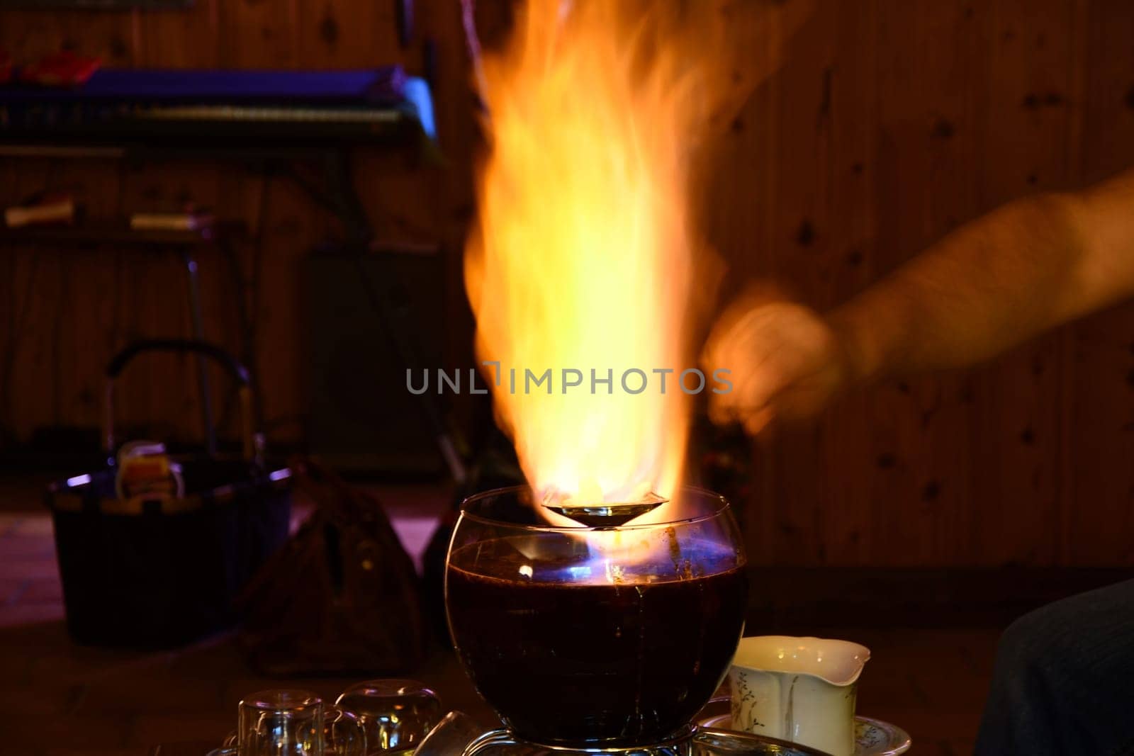 Burning sugarloaf over a bowl of Feuerzangenbowle on a restaurant table