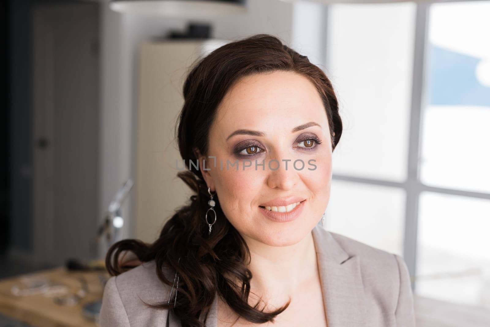 Portrait of a female online store business owner looking away and smiling. Woman doing her small business from home
