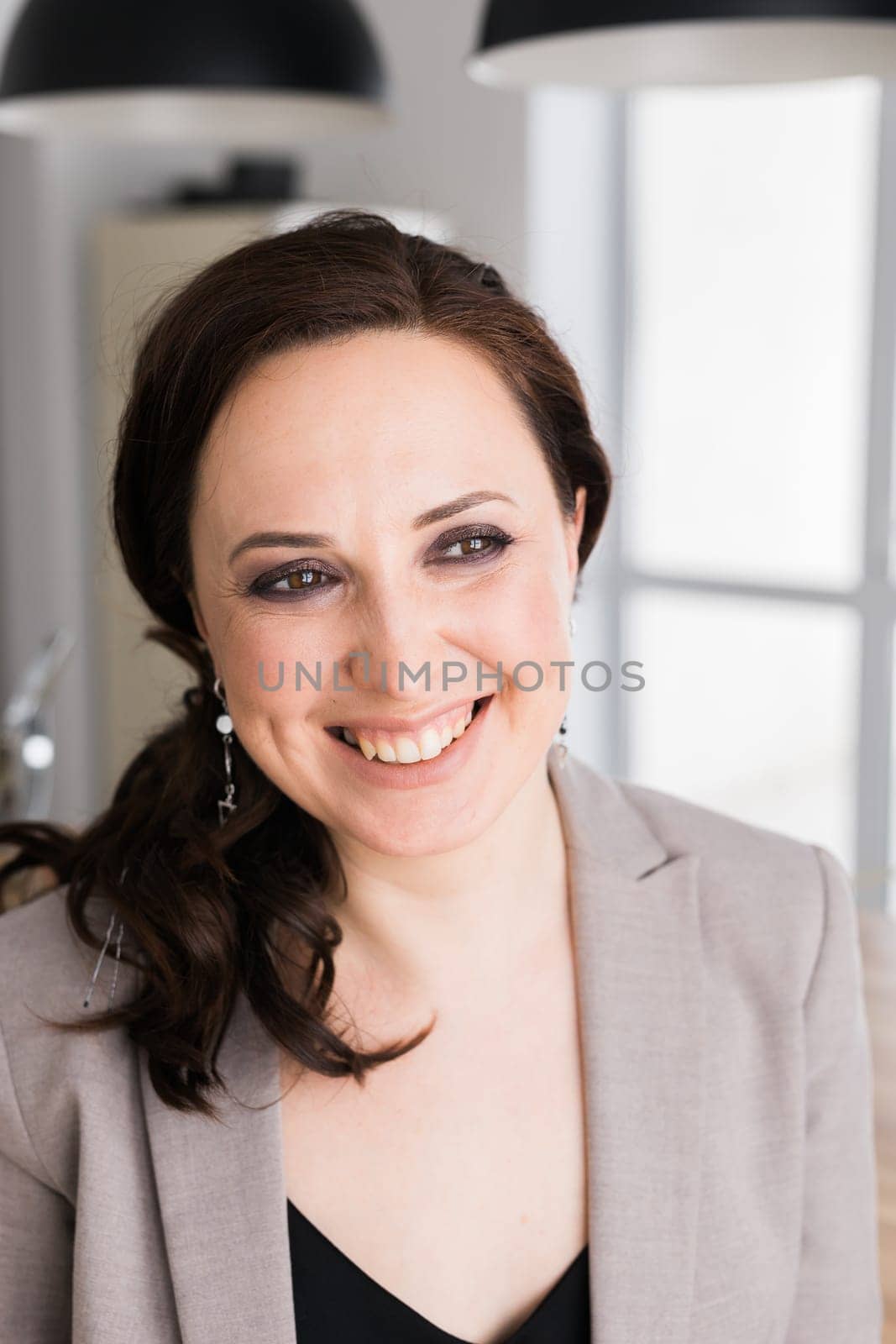 Portrait of a female online store business owner looking away and smiling. Woman doing her small business from home