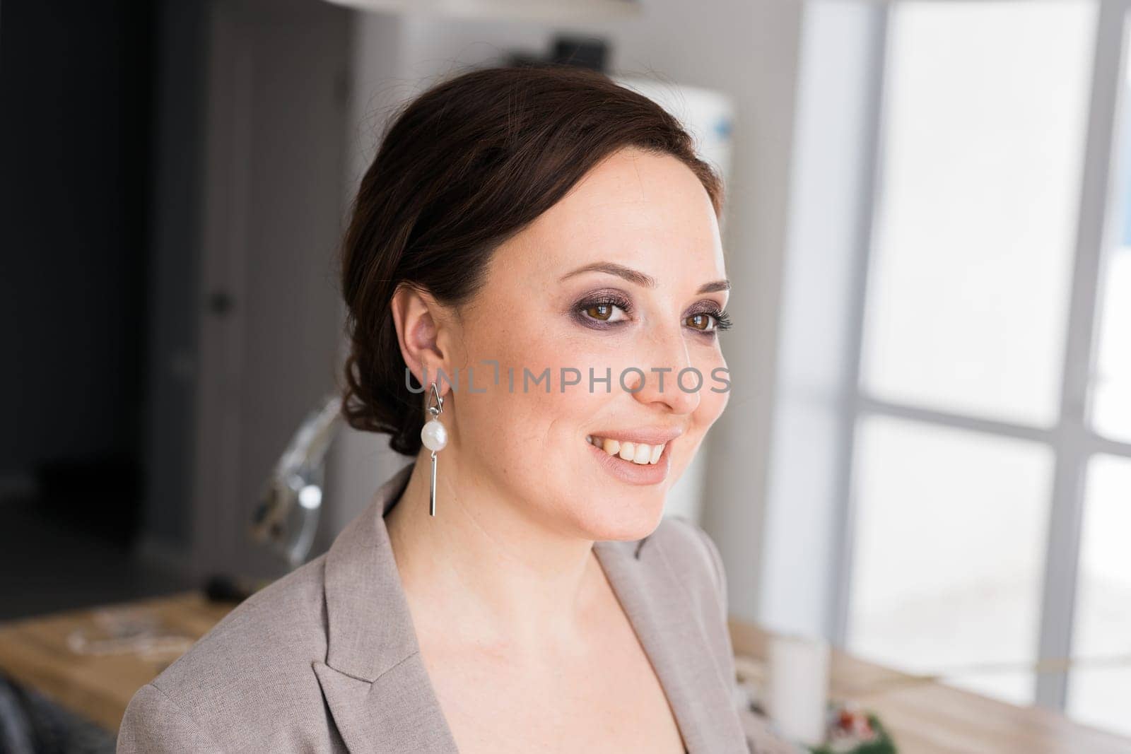 Portrait of a female online store business owner looking away and smiling. Woman doing her small business from home