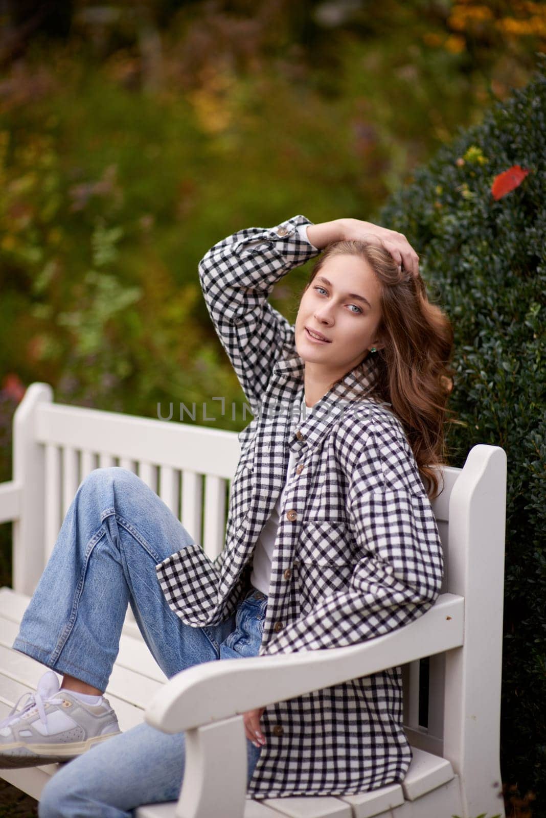 Charming Autumn Casual: Beautiful Girl on Park Bench. Autumn Grace: Stylish Casual Amidst Fall Foliage. Casual Chic in Autumn: Beauty on a Park Bench by Andrii_Ko