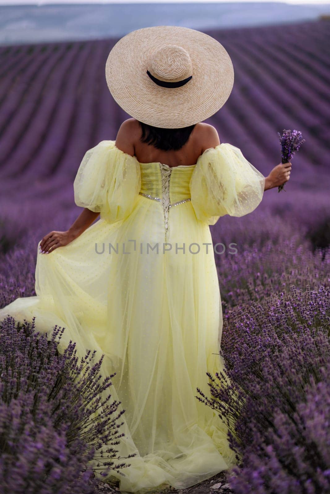 Woman lavender field. Lavender field happy woman in yellow dress in lavender field summer time. Aromatherapy concept, lavender oil, photo session in lavender.