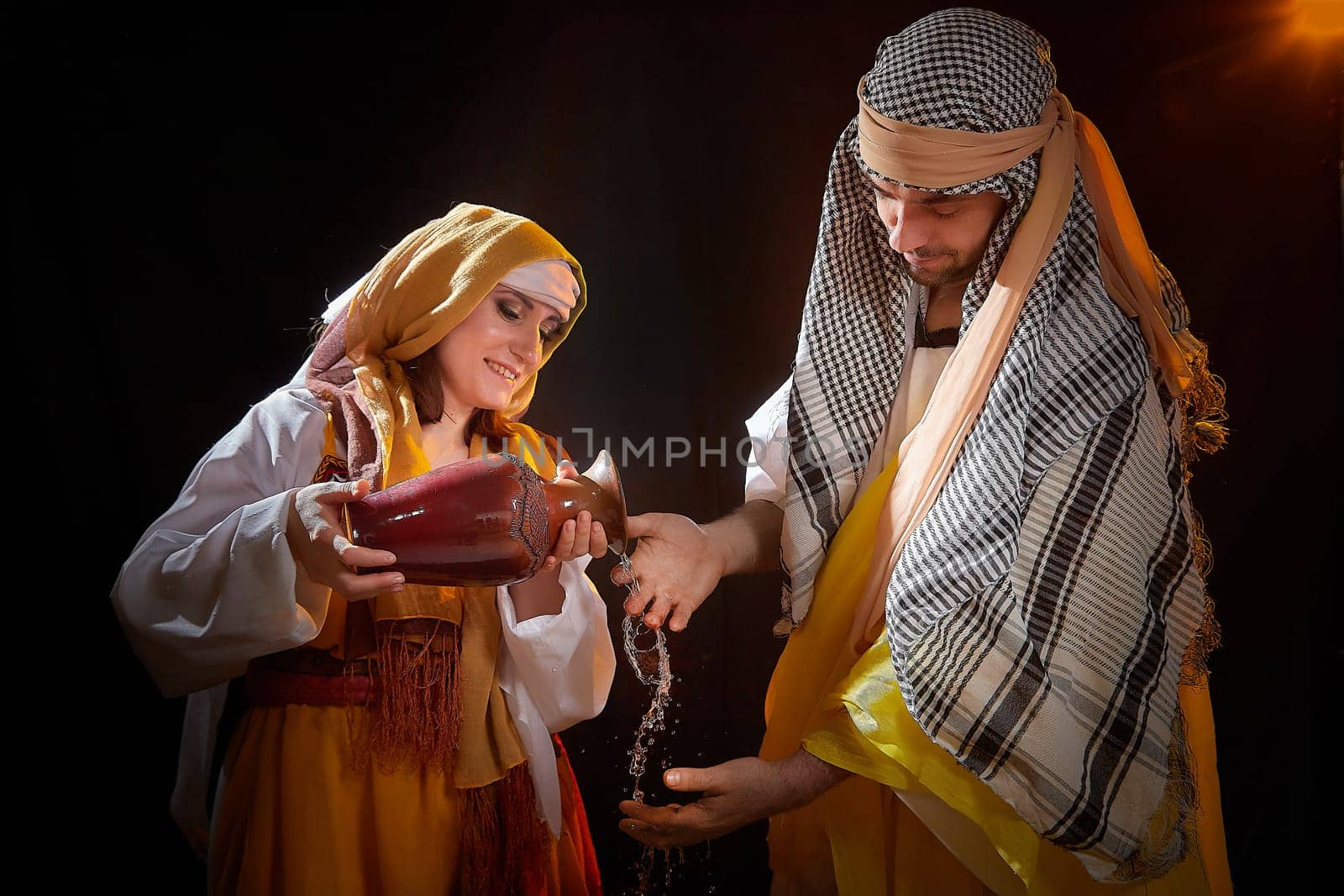 A couple in love or a married couple in stylized Eastern clothing from Israel, Palestine, Iran, Pakistan together. Tender photo session in the style of the Middle East and the Bible