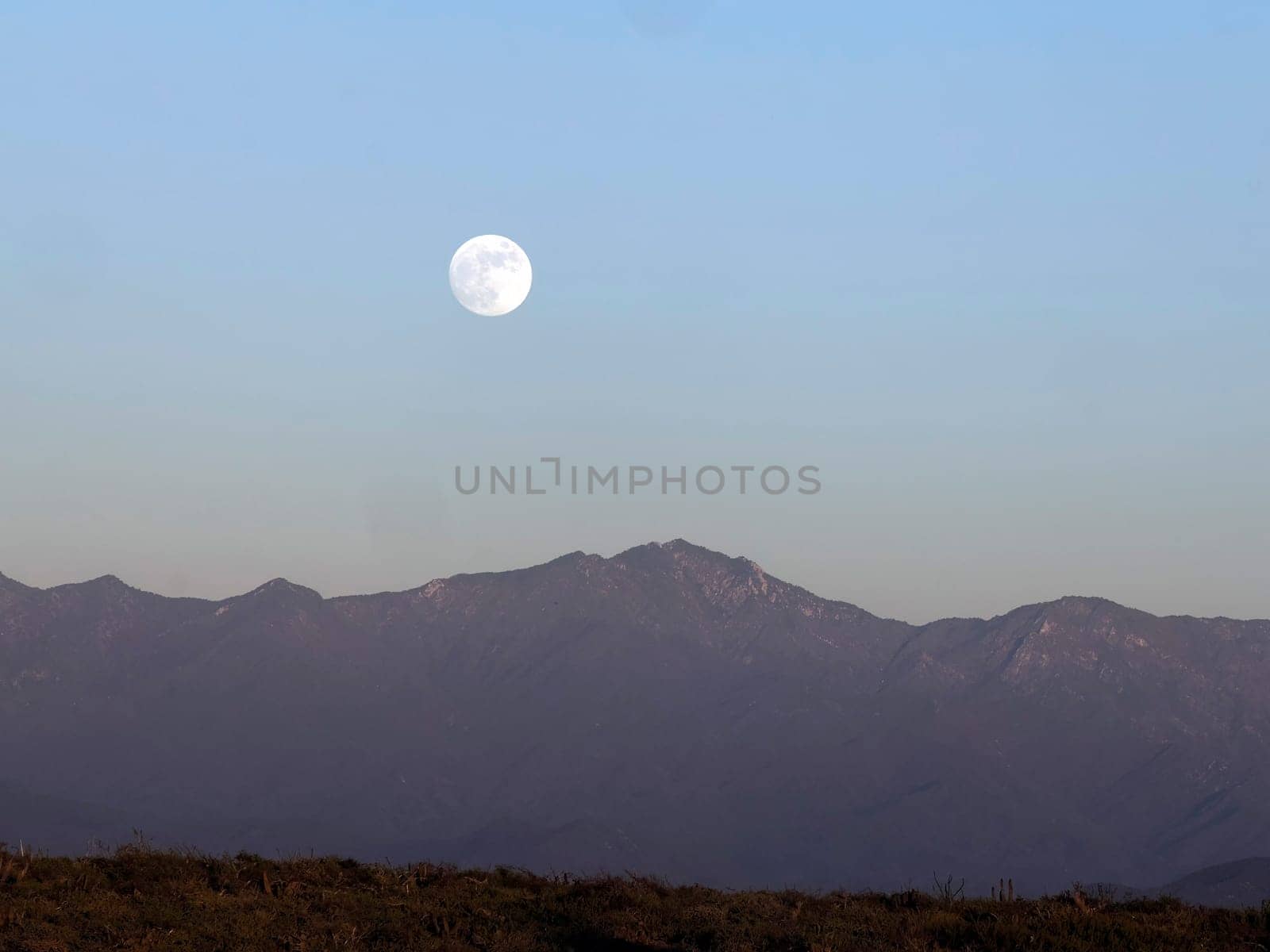 A full moon after sunset in todos santos mexico baja california sur