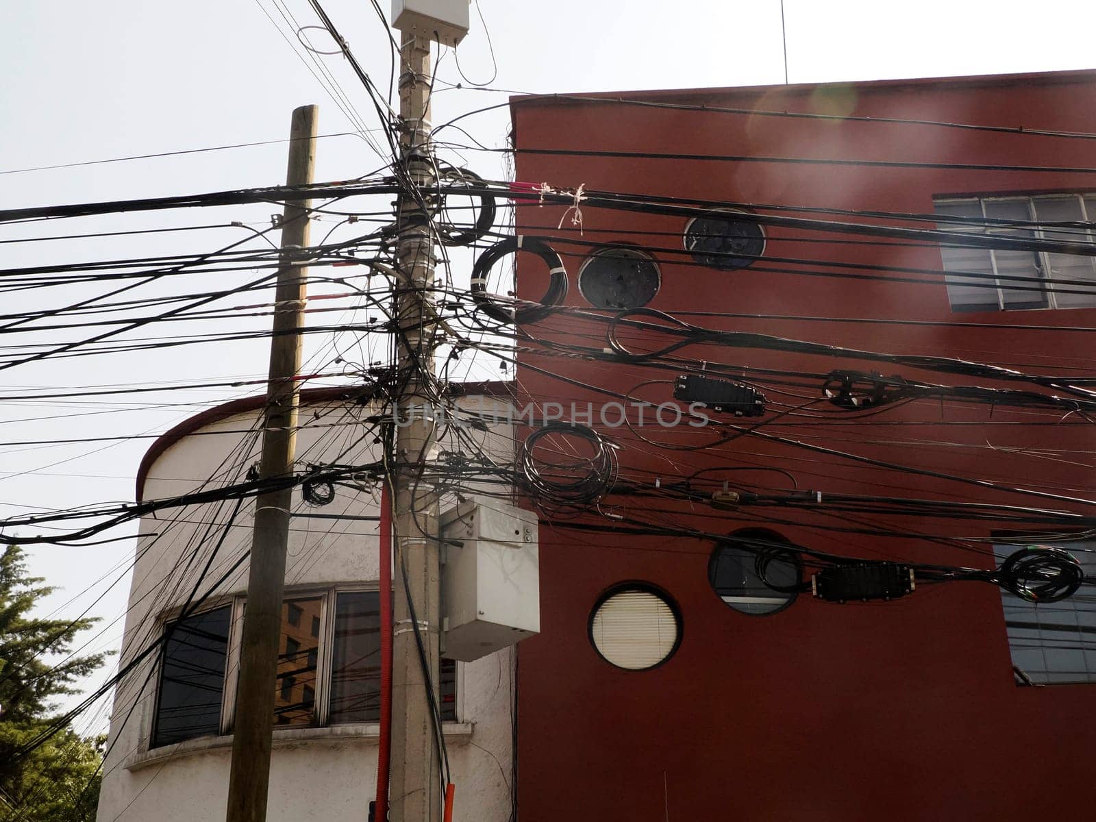 Mexico City, Messed up power lines and connection cables. Many tangled wires on electric poles in the city