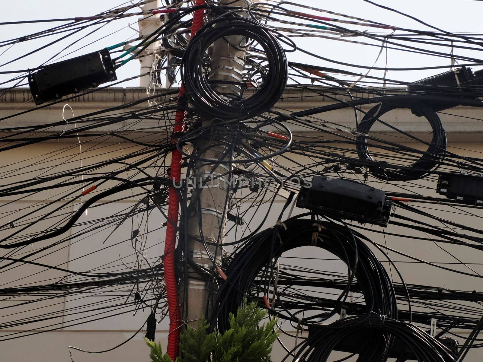 Mexico City, Messed up power lines and connection cables. Many tangled wires on electric poles in the city