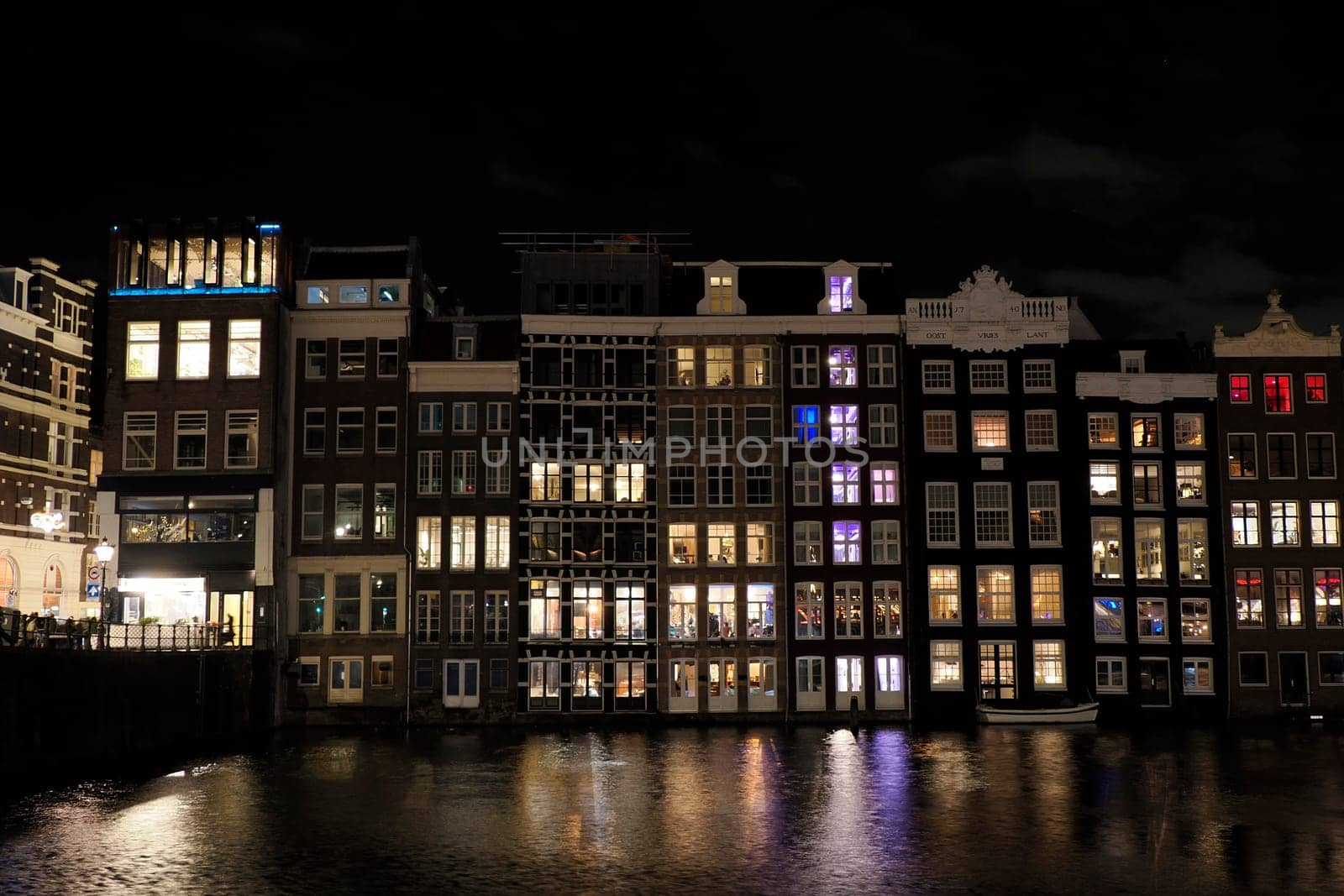 amsterdam ancient buildings over canals, netherlands night view