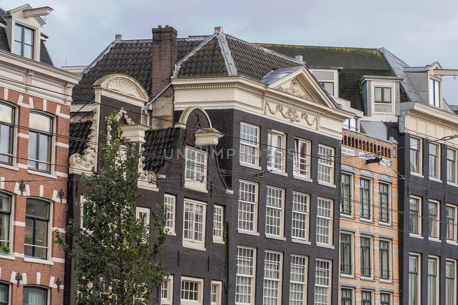 amsterdam ancient buildings over canals by AndreaIzzotti
