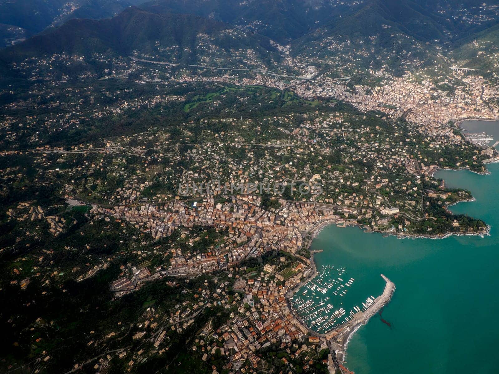 Rapallo Genoa aerial view before landing to airport by airplane during a sea storm tempest hurricane by AndreaIzzotti