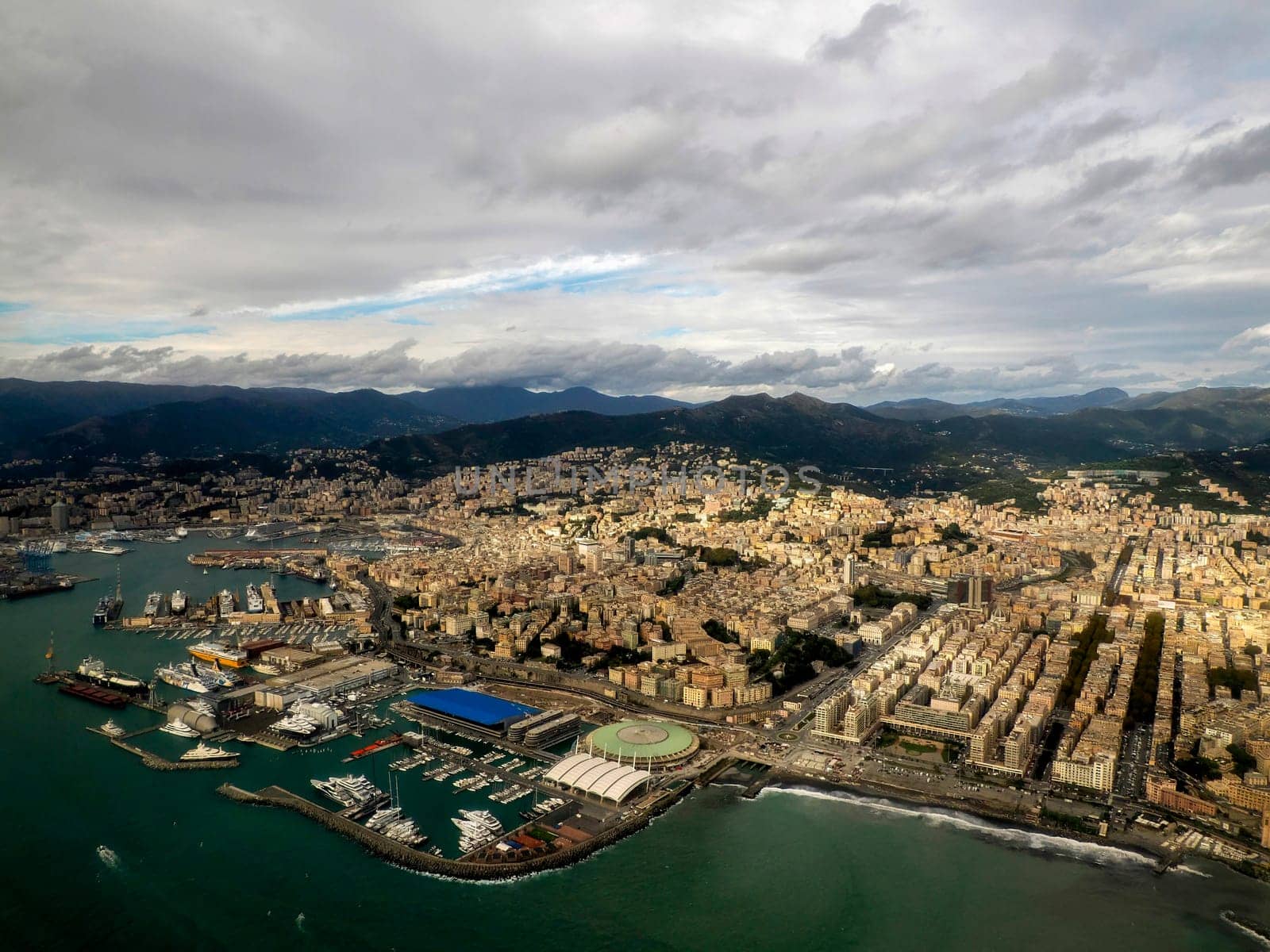 Foce Genoa aerial view before landing to airport by airplane during a sea storm tempest hurricane by AndreaIzzotti