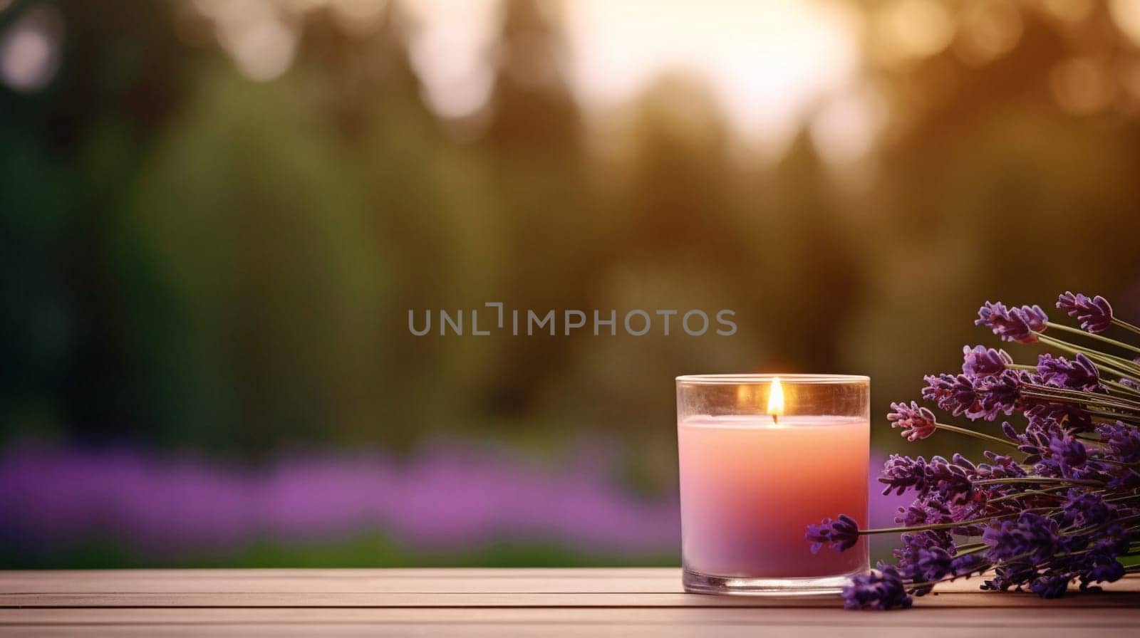A burning candle and lavender flowers against the background of a garden. Banner with copy space. by kizuneko