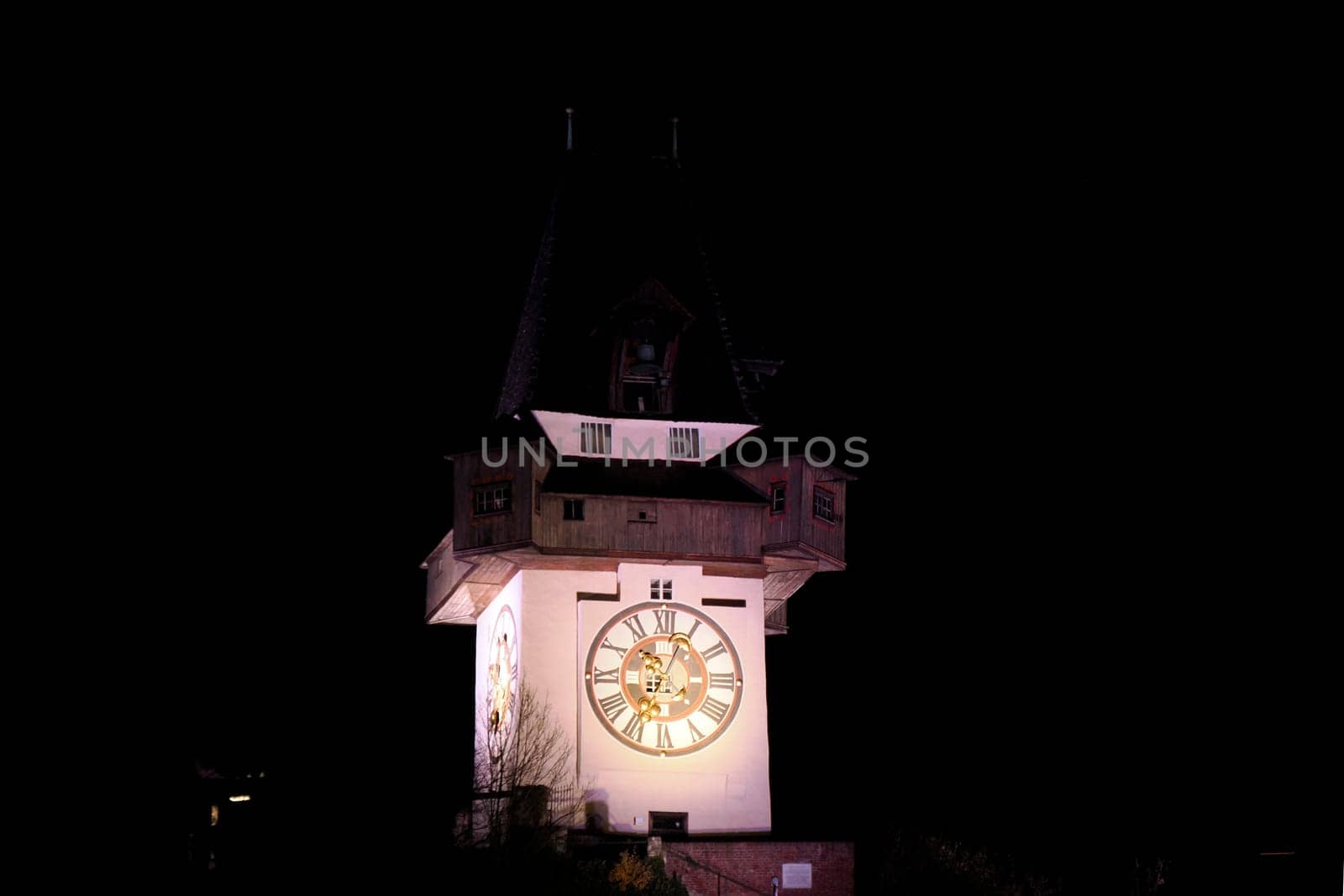 Night view of the clock tower in Graz Austria in winter season by AndreaIzzotti